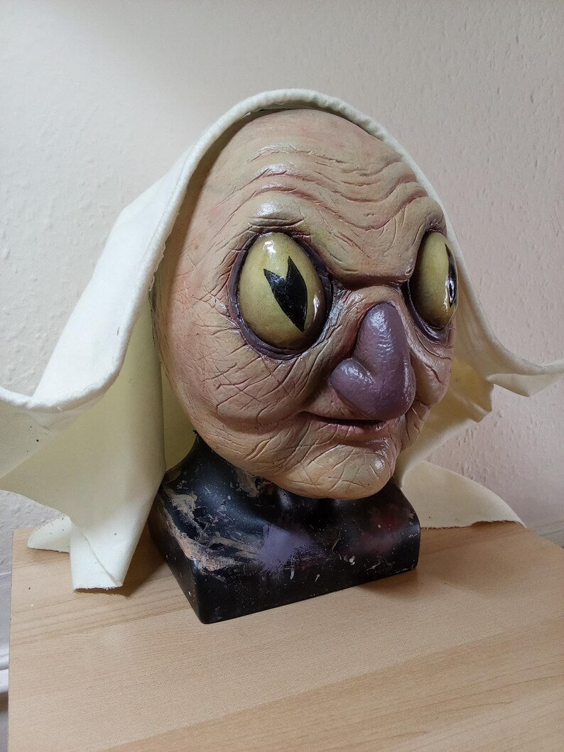 Auntie Whispers replica latex display mask prop over the garden wall