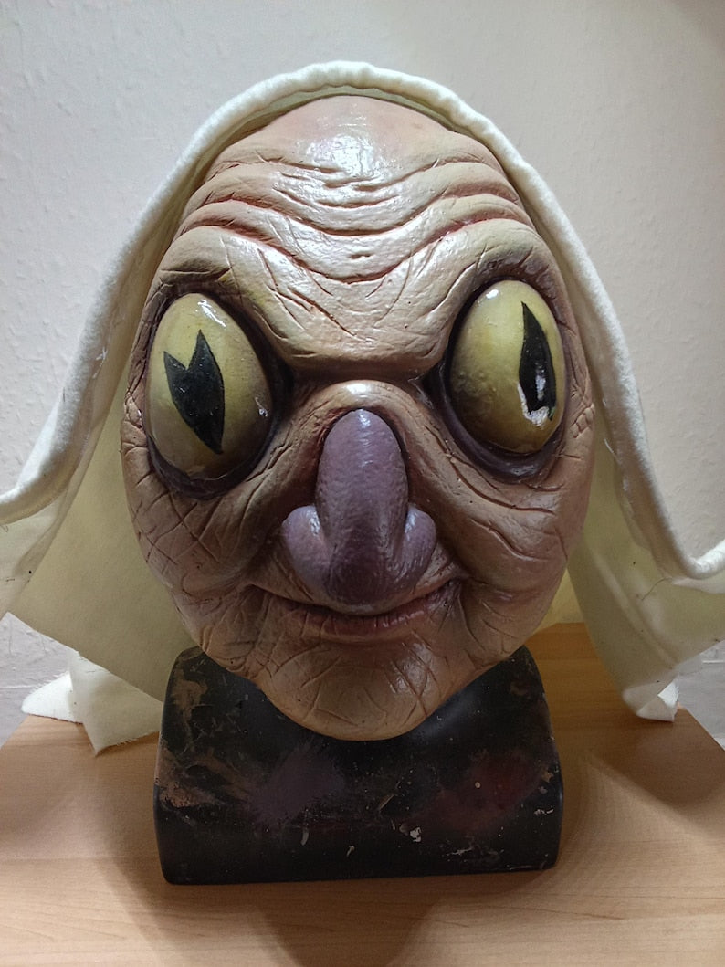 Auntie Whispers replica latex display mask prop over the garden wall